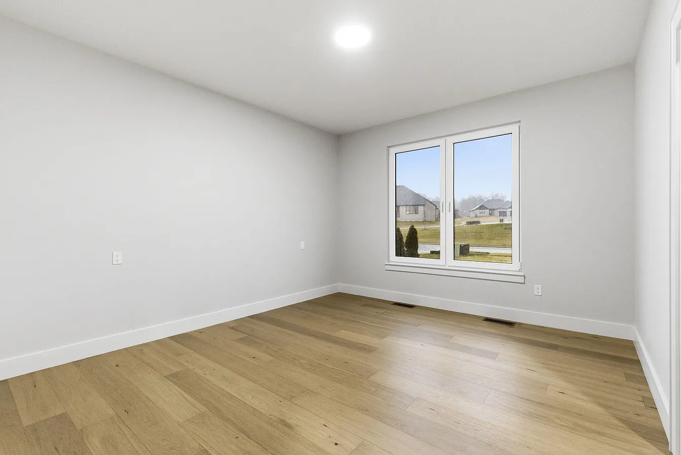 White double swing window in a new-construction room
