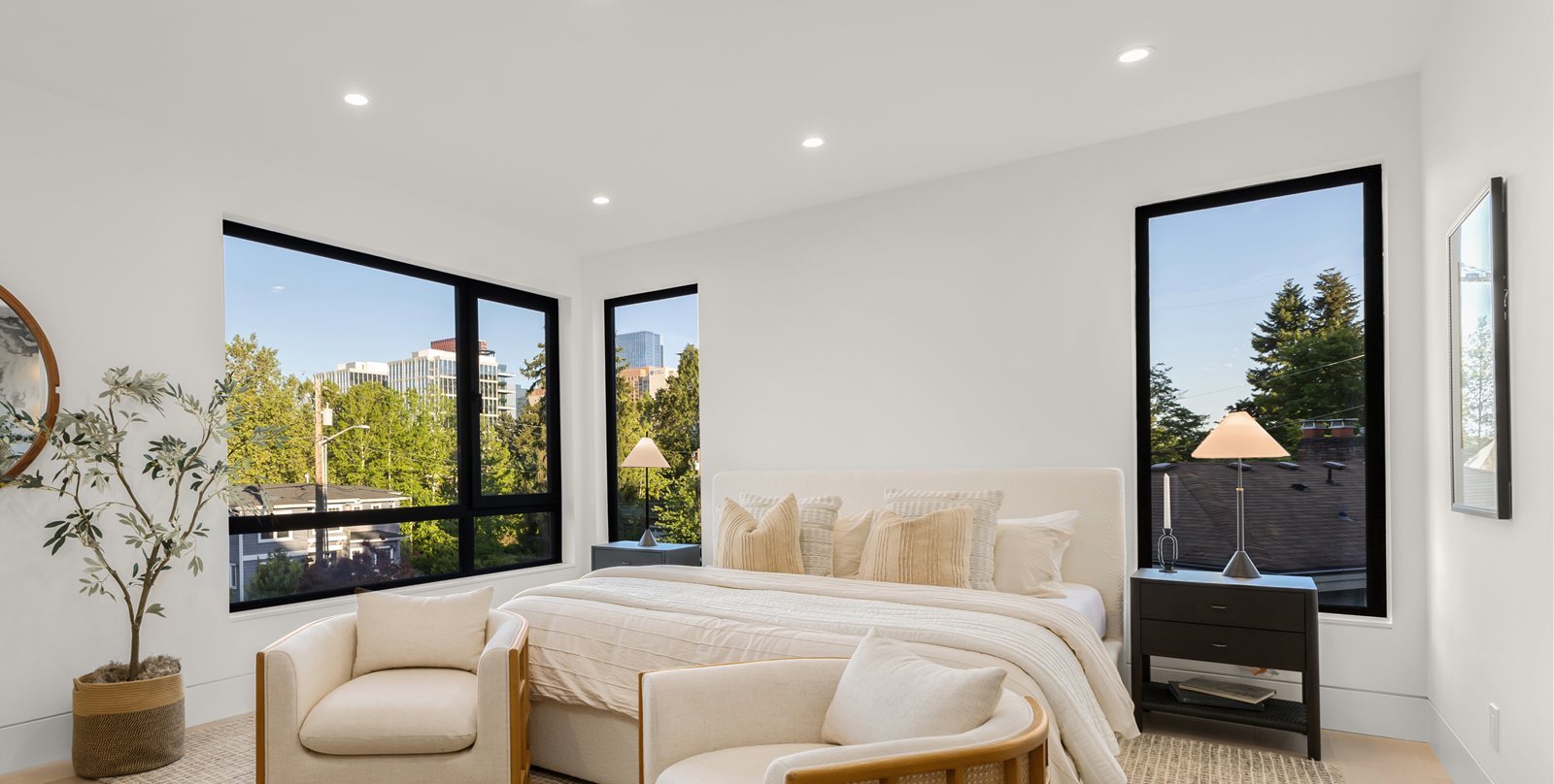 Bedroom with black-framed windows and skyline views