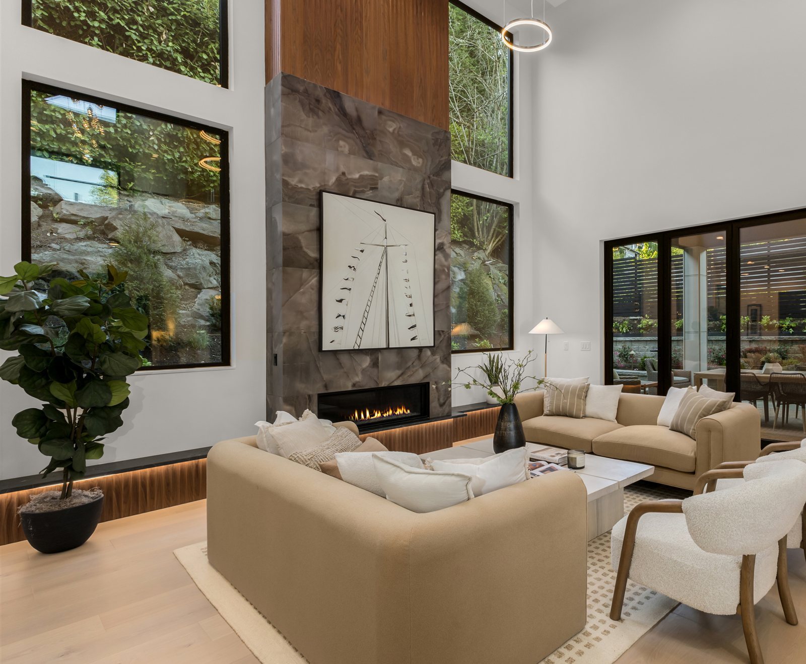 Two-story great room with tall black-framed windows