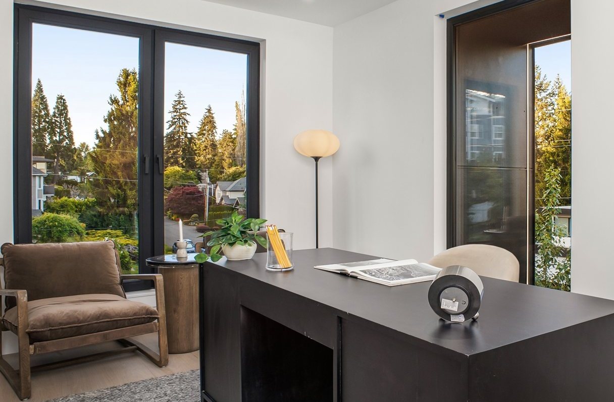 Home office with floor-to-ceiling black-framed windows
