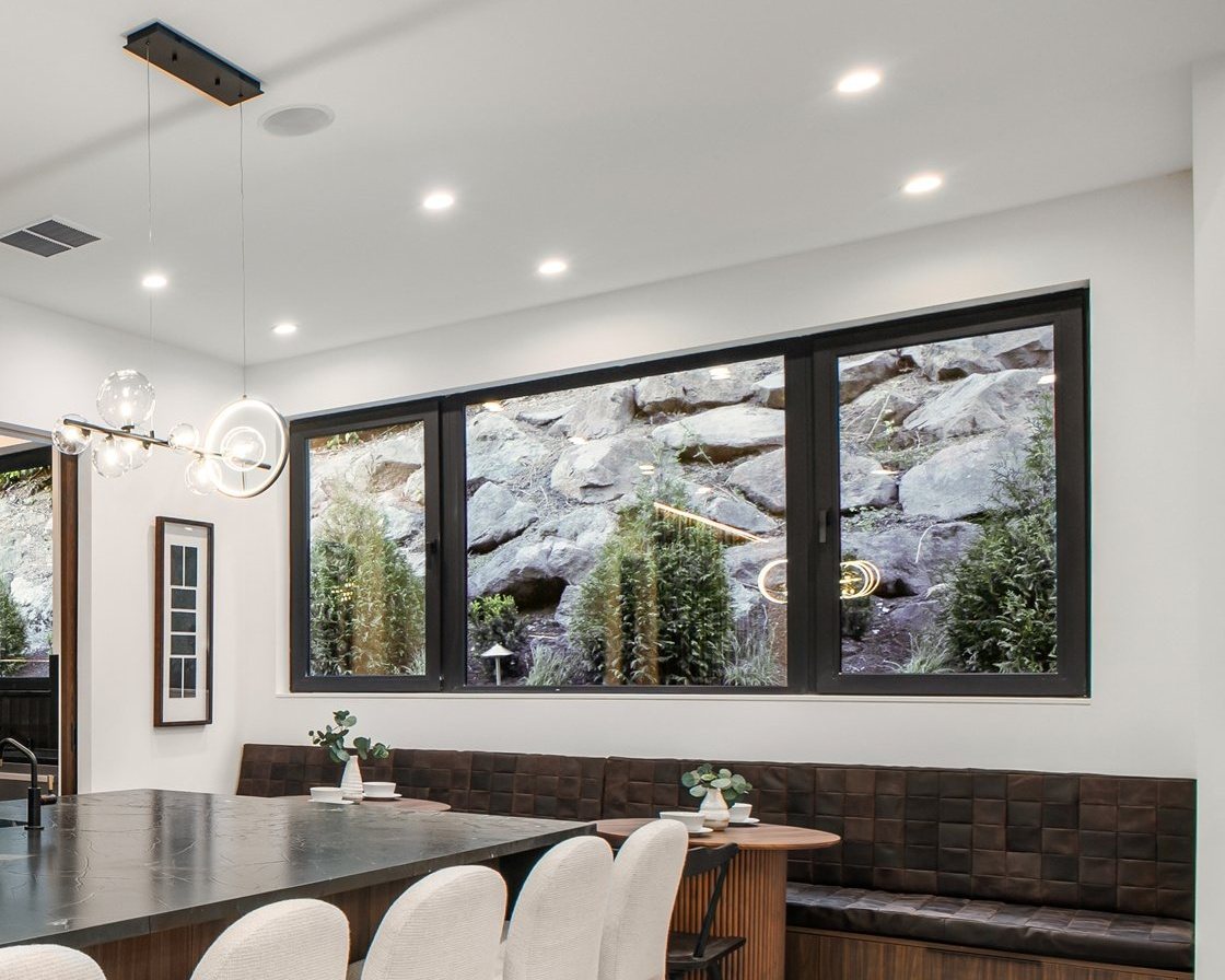Kitchen with a band of black-framed picture windows