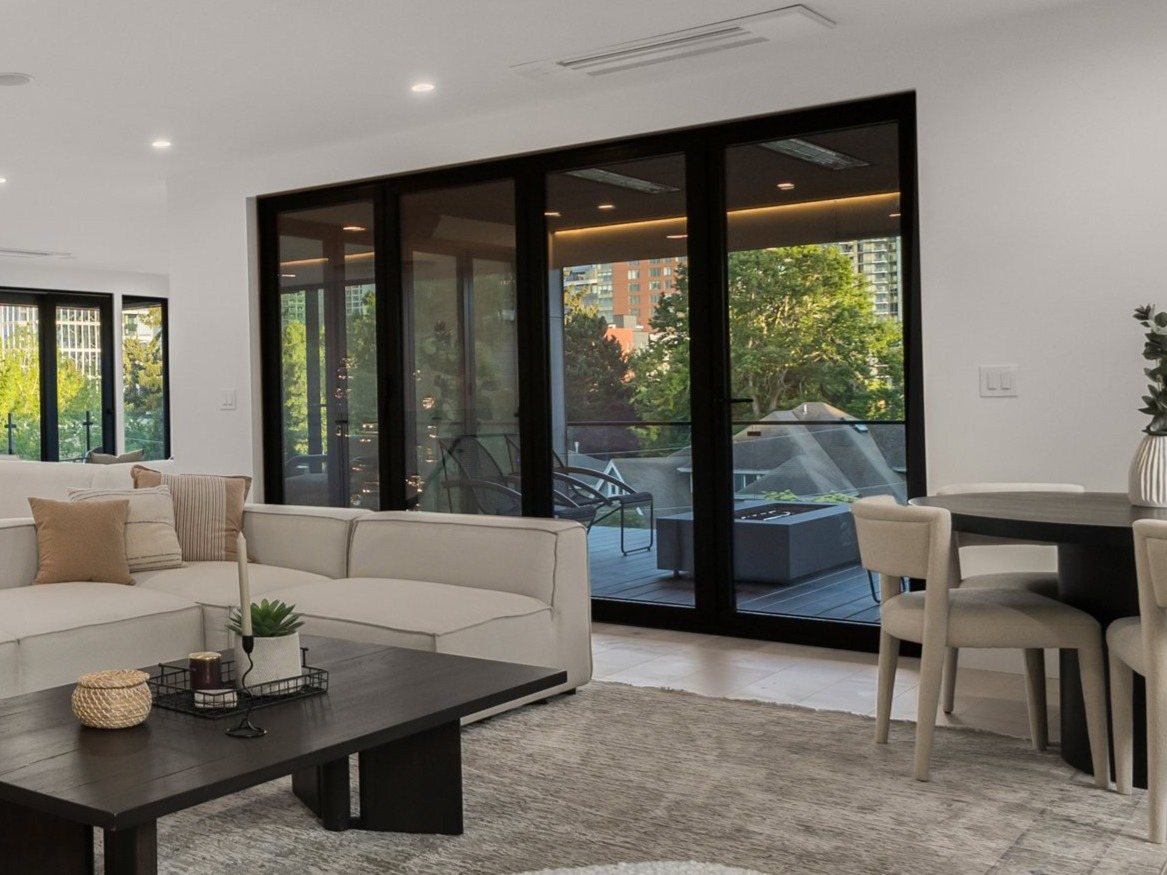 Living room with a wall of black-framed sliding glass doors