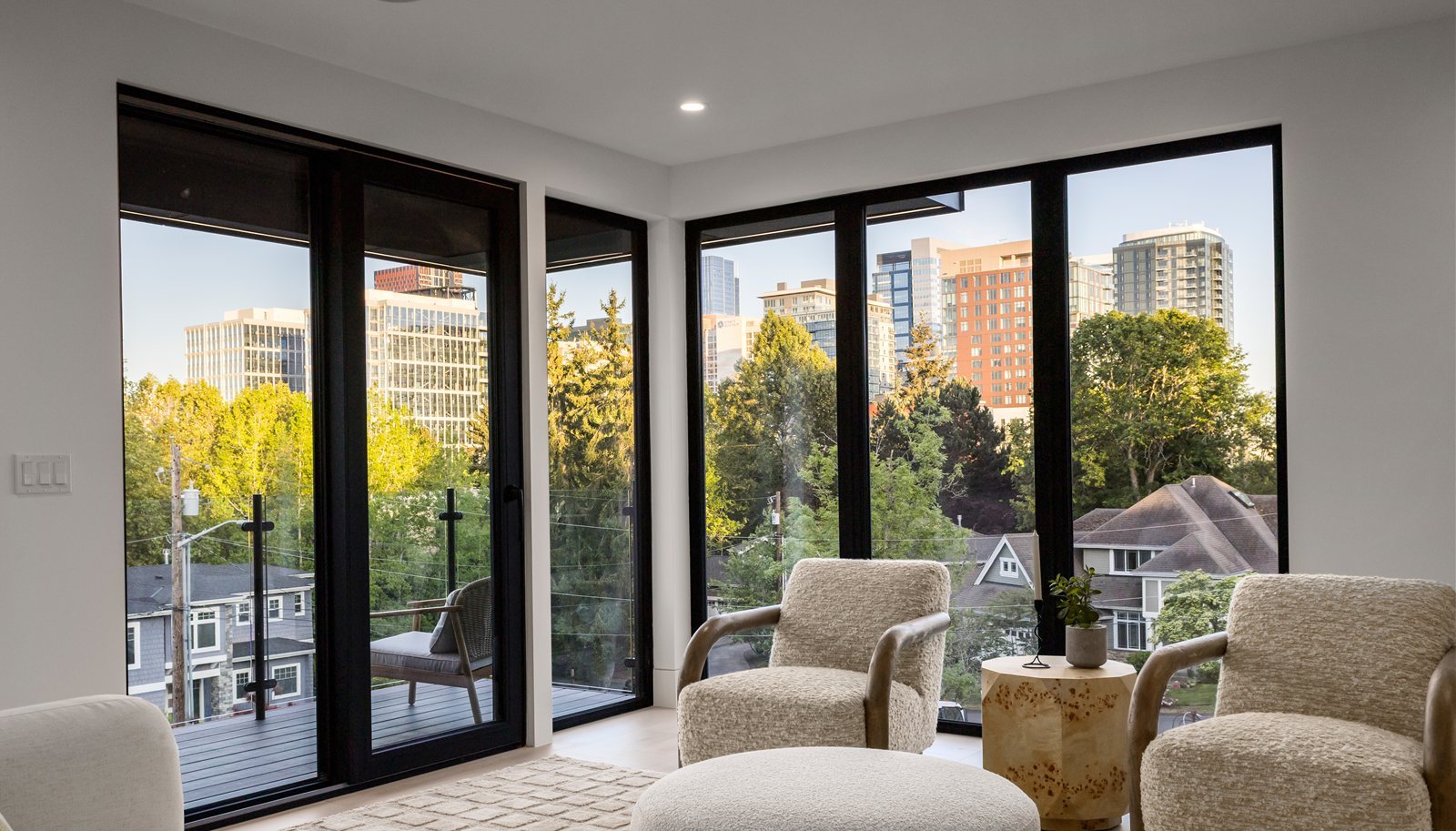 Sitting room with floor-to-ceiling glass and city skyline views